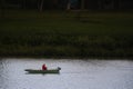 Old man, senior male relaxed and fishing on the Tisza river on a small rowing boat Royalty Free Stock Photo