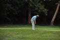 Old man senior practicing golf in the Green grass field - activity concept Royalty Free Stock Photo