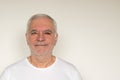 Old man senior white t shirt closeup next to the wall healthy happy