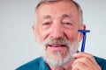 Old man shaver gray-haired beard blue disposable razor in studio white background Royalty Free Stock Photo