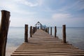 The old man sits on the pier and looks at the sea Royalty Free Stock Photo