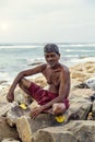 Old man sittiing on a rock watching the sea Royalty Free Stock Photo