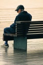 Old man sitting alone on a bench