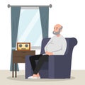 Old man sitting on couch looking out to window and listening to a radio