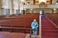 Elderly man sitting in an empty church