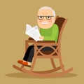 Old man sitting in rocking chair and newspaper Royalty Free Stock Photo