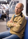 Old man sleeping in subway car