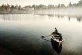 Old man in a small fishing boat on a river in the early morning with dew over the water. 10/12/2018 - Sesto Calende, Italy Royalty Free Stock Photo