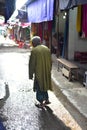 An old man standing around an urban marketplace unique photograph