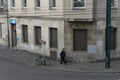 A man stands near a building in a European city