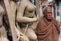 Old man stands near the woman sculpture Royalty Free Stock Photo