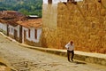 Old man, steep colonial street