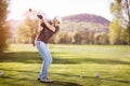 Old man swinging golf club. Royalty Free Stock Photo