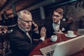 Old Man talking on Phone on Business Meeting