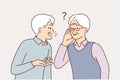 Old man talking to deaf friend who puts hand to ear and is having problems after hearing aid is broken Royalty Free Stock Photo