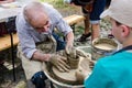 Old man teaching pottery to children at Street Delivery Royalty Free Stock Photo