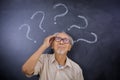 Old man thinking an idea under question marks Royalty Free Stock Photo