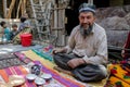 Old man in traditional clothes drinks tea in Tajikistan