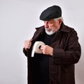 Old man in a trench coat is offering to sell toilet paper at exorbitant prices