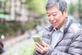 Old man use phone Royalty Free Stock Photo