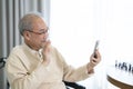 Old man use smart phone and video call to his family Royalty Free Stock Photo