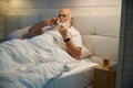 Old man uses nasal spray and a napkin Royalty Free Stock Photo