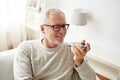 Old man using voice command recorder on smartphone