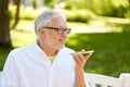 Old man using voice command recorder on smartphone Royalty Free Stock Photo