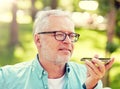 Old man using voice command recorder on smartphone Royalty Free Stock Photo