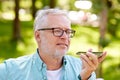 Old man using voice command recorder on smartphone Royalty Free Stock Photo