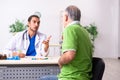 Old man visiting young male doctor gastroenterologist