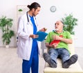 Old man visiting young male doctor gastroenterologist