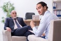 Old man visiting young male doctor psychologist Royalty Free Stock Photo