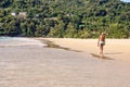 Old man. Walking along beach. Warm sand