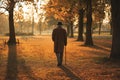 Old Man Walking in Autumn Park Royalty Free Stock Photo