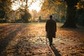Old Man Walking in Autumn Park Royalty Free Stock Photo