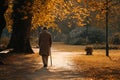 Old Man Walking in Autumn Park Royalty Free Stock Photo