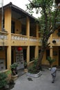 An old man is walking in the courtyard of a Buddhist temple in Hanoi (Vietnam)