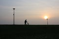 Old man is walking with his rollator at sunset. Royalty Free Stock Photo