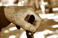 Old man with a walking stick, in sepia toning