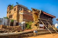 Old man walks around a building destroyd by earthquake in Nepal