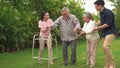 The old man was walking with a walker in the backyard, with a family with a wife, daughter and son to support, until he could walk