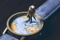 Old man on watches with world map, vintage toned photo. World travel banner. Senior traveler figurine. Royalty Free Stock Photo