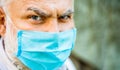 Old man wearing face mask. Portrait of an old man, years old, in a medical mask. Concept danger of coronavirus for the Royalty Free Stock Photo