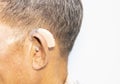 An old man wears a hearing aid Royalty Free Stock Photo