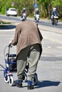 Old man with a wheeled walker on the street