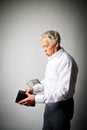 Old man in white and empty wallet. One dollar and taxes. Royalty Free Stock Photo