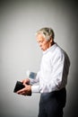 Old man in white and empty wallet. Twenty Euro and taxes. Royalty Free Stock Photo