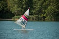 Old man wind surfing on the lake of reiningue Royalty Free Stock Photo