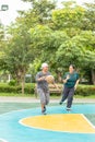 Old man and woman to play basketball in the morning so happily. Royalty Free Stock Photo